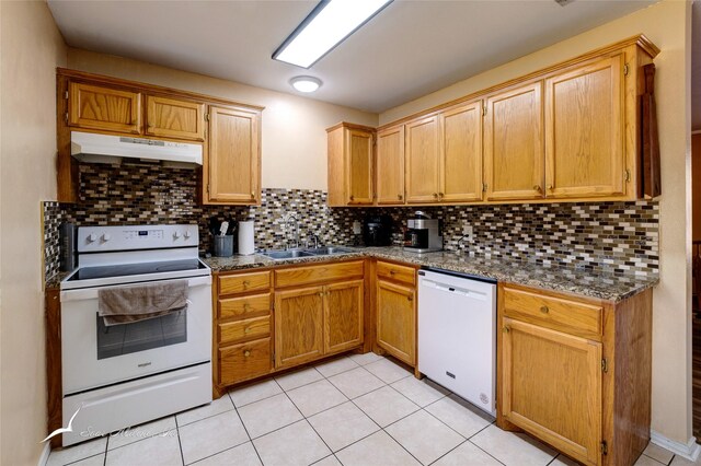 kitchen with sink, white appliances, backsplash, and light tile patterned floors