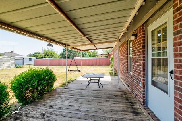 wooden terrace with a shed