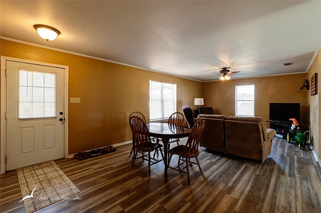 dining space with dark hardwood / wood-style flooring, ceiling fan, and crown molding