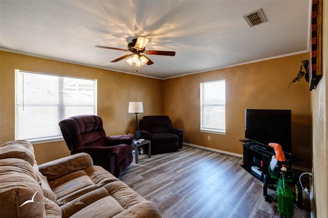 living room with ceiling fan, crown molding, and hardwood / wood-style flooring