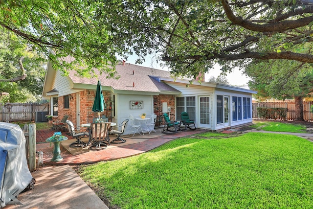 back of property with a patio and a lawn