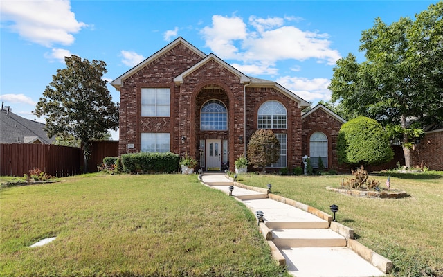 view of property featuring a front lawn