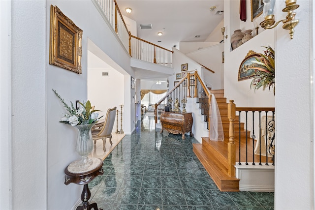 entrance foyer featuring a high ceiling and tile patterned flooring