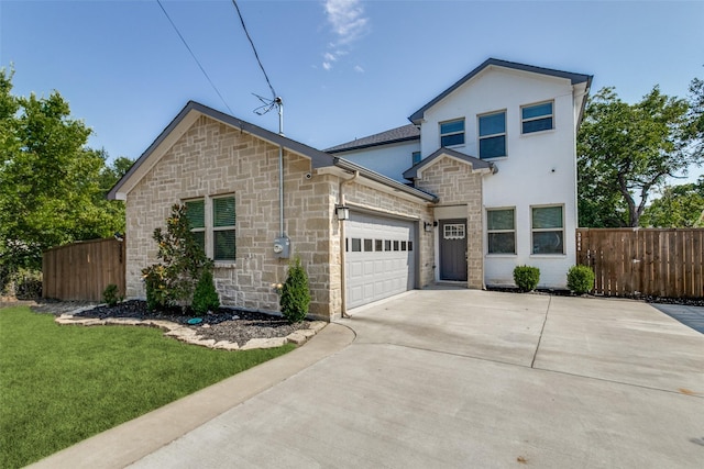 view of front of property with a garage and a front lawn