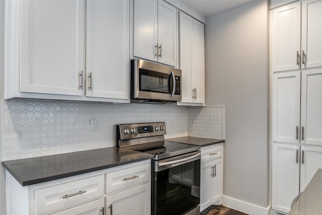 kitchen with appliances with stainless steel finishes and white cabinetry