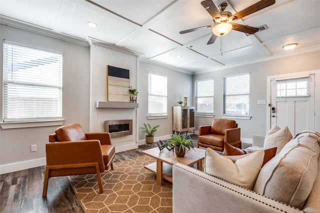 living room featuring coffered ceiling, a large fireplace, ceiling fan, crown molding, and dark hardwood / wood-style floors