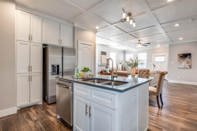 kitchen with appliances with stainless steel finishes, ceiling fan, sink, a center island with sink, and white cabinetry