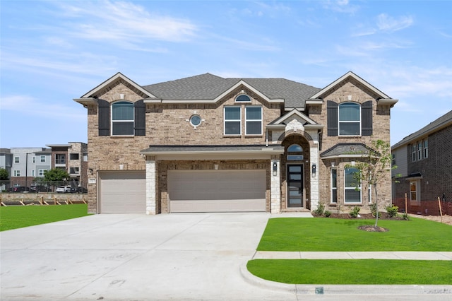 view of front of home featuring a front yard and a garage