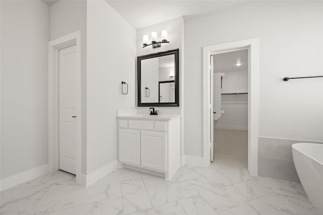 bathroom featuring vanity and a tub