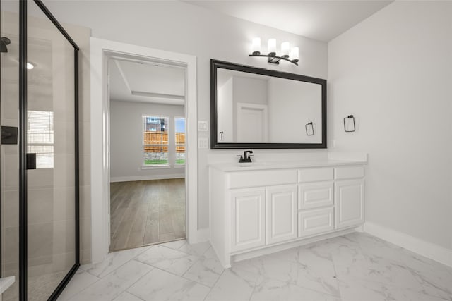 bathroom with wood-type flooring, an enclosed shower, and vanity