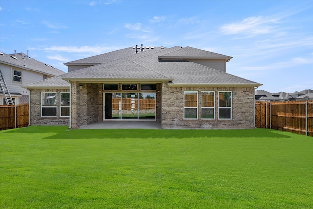 back of property featuring a lawn and a patio