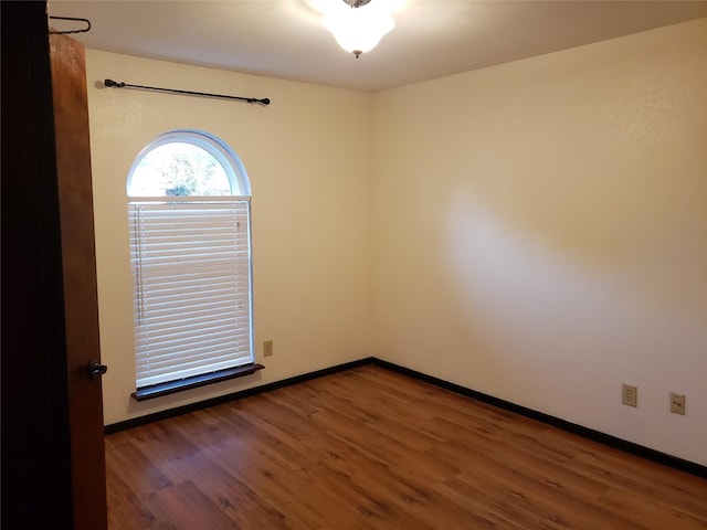 spare room with dark hardwood / wood-style floors