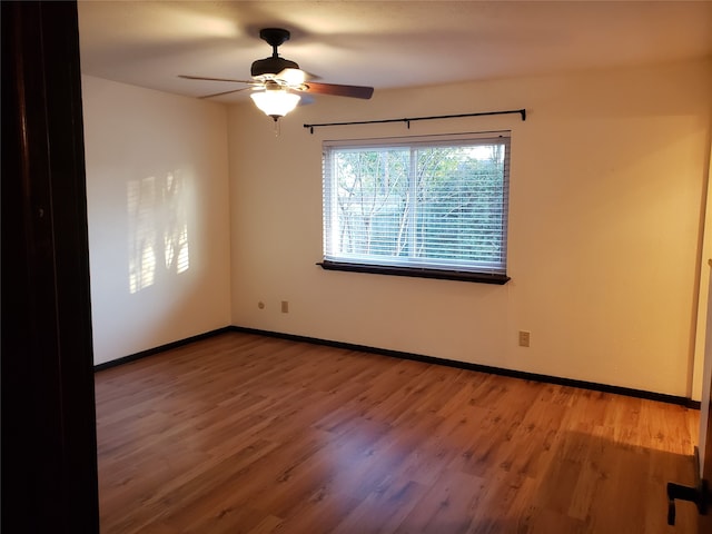 spare room featuring ceiling fan and hardwood / wood-style floors