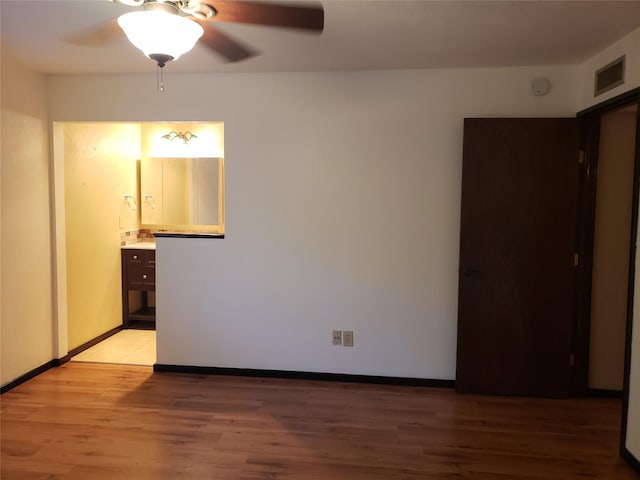 unfurnished room with ceiling fan and light hardwood / wood-style flooring