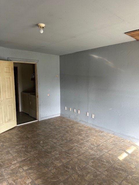 tiled empty room with separate washer and dryer