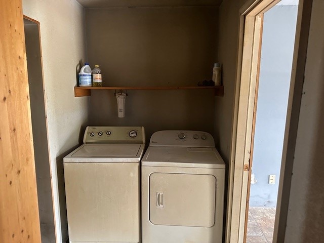 clothes washing area featuring washer and dryer and tile patterned flooring