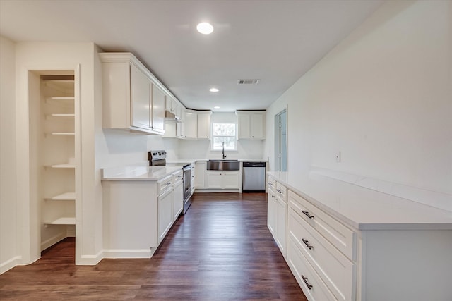 kitchen featuring sink, dark hardwood / wood-style flooring, white cabinets, and stainless steel appliances