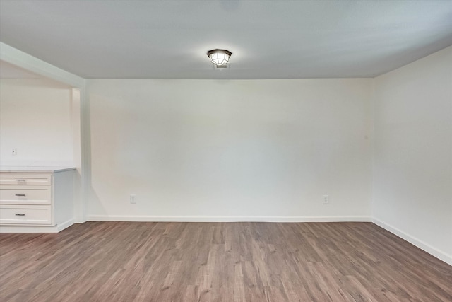 spare room with hardwood / wood-style flooring