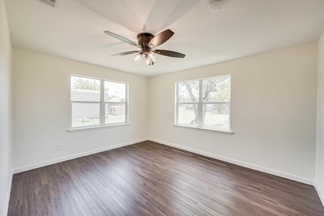 empty room featuring dark hardwood / wood-style flooring and ceiling fan