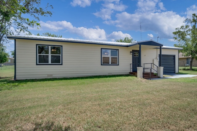 rear view of house featuring a lawn