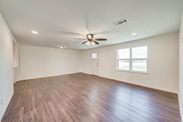 spare room featuring wood-type flooring and ceiling fan