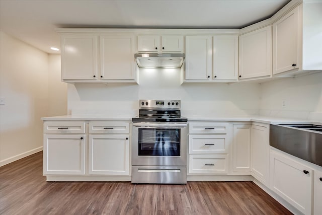 kitchen with stainless steel range with electric stovetop, hardwood / wood-style flooring, and white cabinets