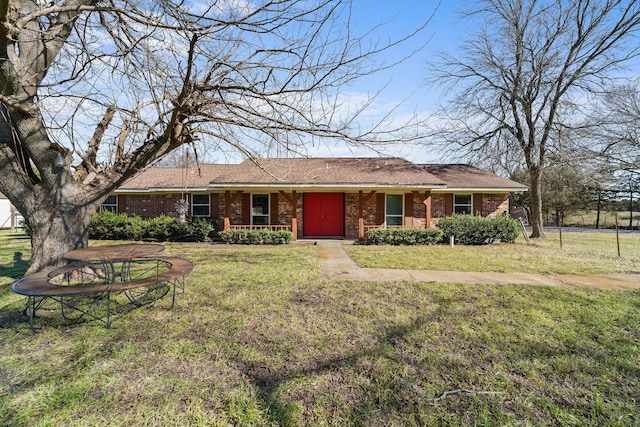 ranch-style house with a front lawn and covered porch