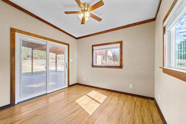 spare room with plenty of natural light, ceiling fan, and light wood-type flooring