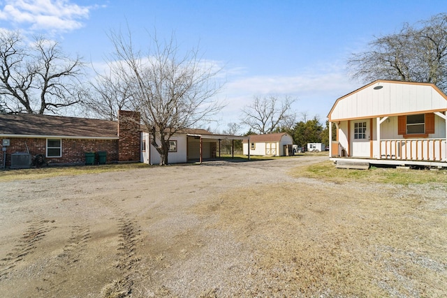 view of yard featuring covered porch and central AC