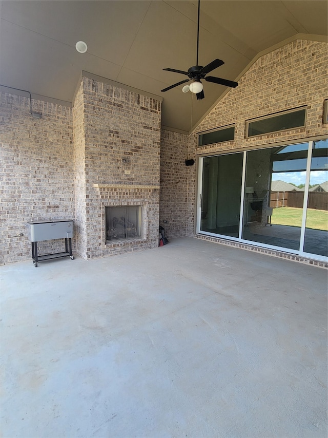 view of patio / terrace with ceiling fan and a large fireplace