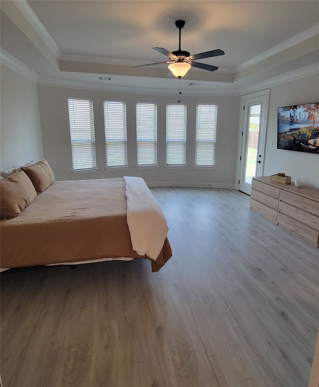 bedroom featuring light hardwood / wood-style flooring, ceiling fan, access to exterior, and crown molding