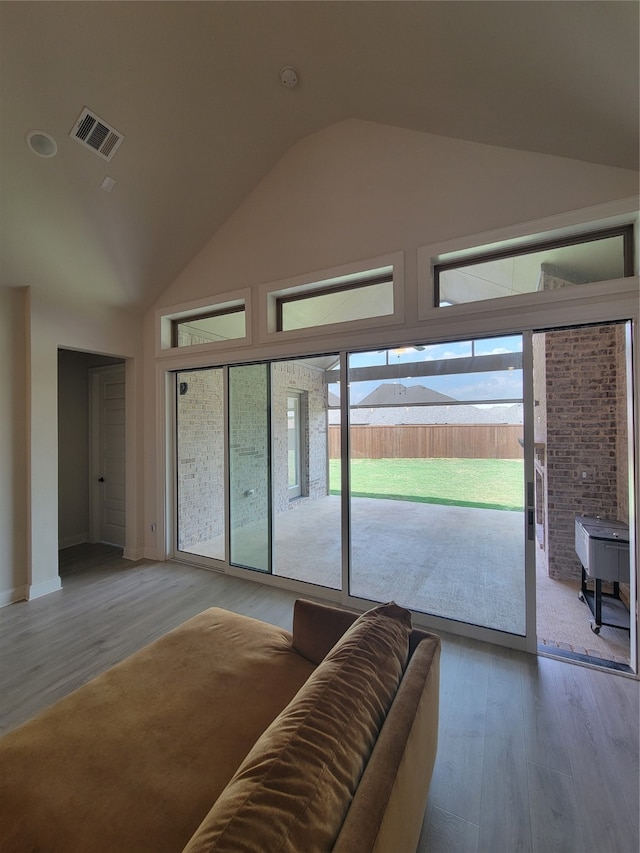 living room featuring lofted ceiling and hardwood / wood-style floors