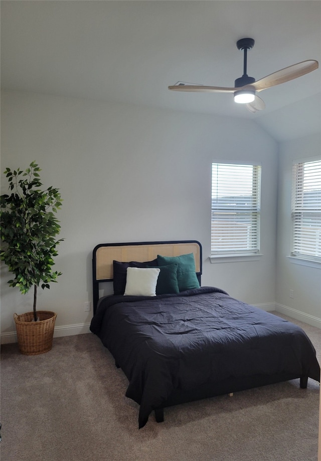 carpeted bedroom featuring ceiling fan and vaulted ceiling