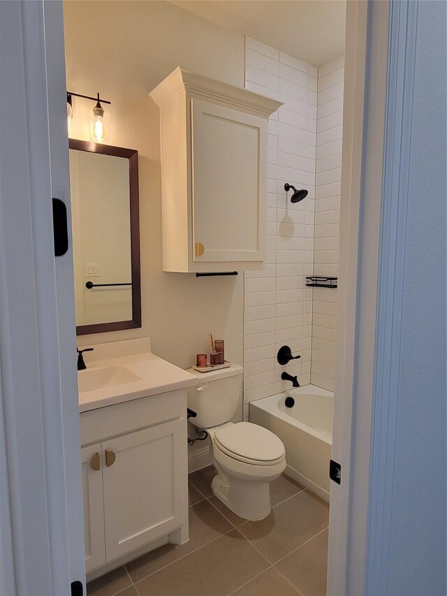 full bathroom with tile patterned flooring, tiled shower / bath, toilet, and vanity