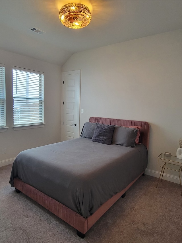 bedroom featuring carpet floors and lofted ceiling