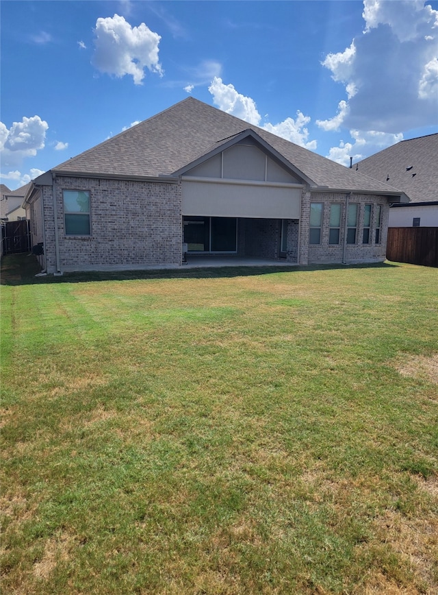 rear view of property with a yard