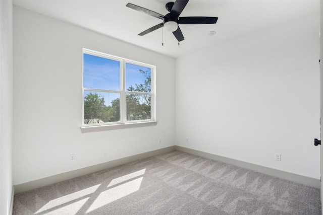 carpeted spare room with ceiling fan