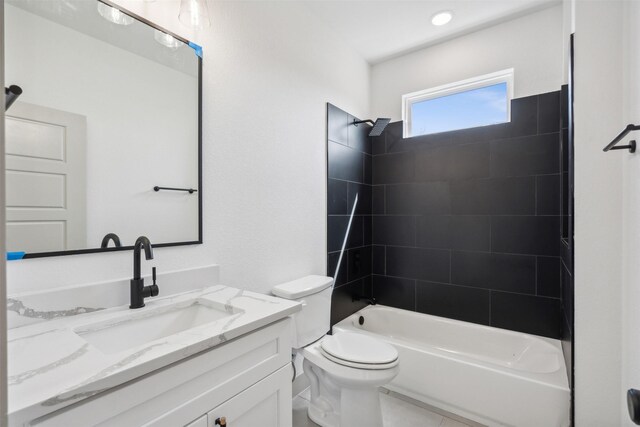 full bathroom with tile patterned floors, toilet, vanity, and tiled shower / bath