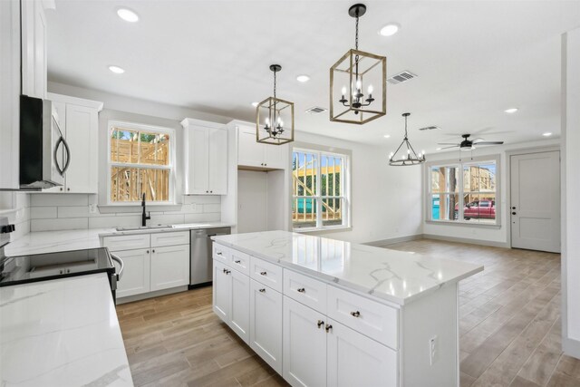 kitchen with plenty of natural light, stainless steel appliances, and backsplash