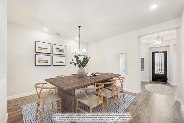 unfurnished dining area with wood-type flooring and a chandelier