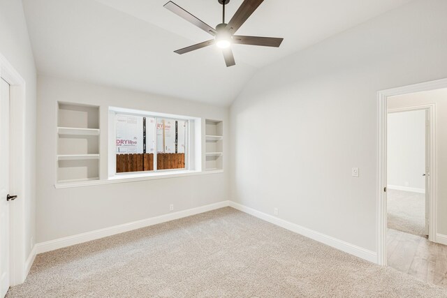 unfurnished bedroom with lofted ceiling, light colored carpet, ceiling fan, and a closet