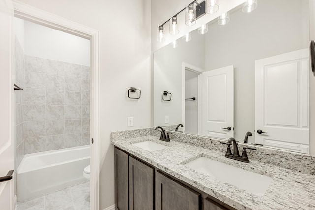 full bathroom featuring vanity, toilet, tiled shower / bath combo, and tile patterned flooring