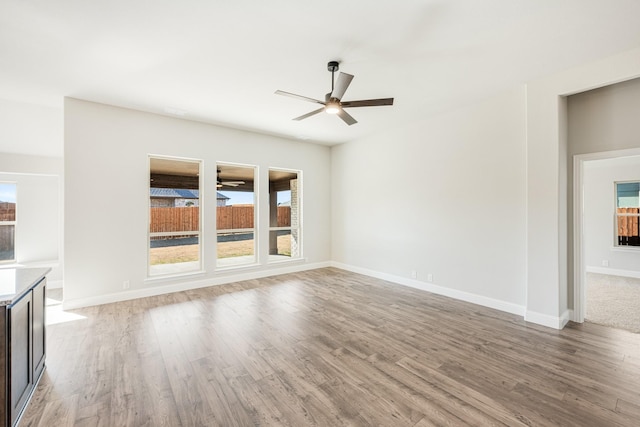 unfurnished living room featuring light hardwood / wood-style flooring and ceiling fan