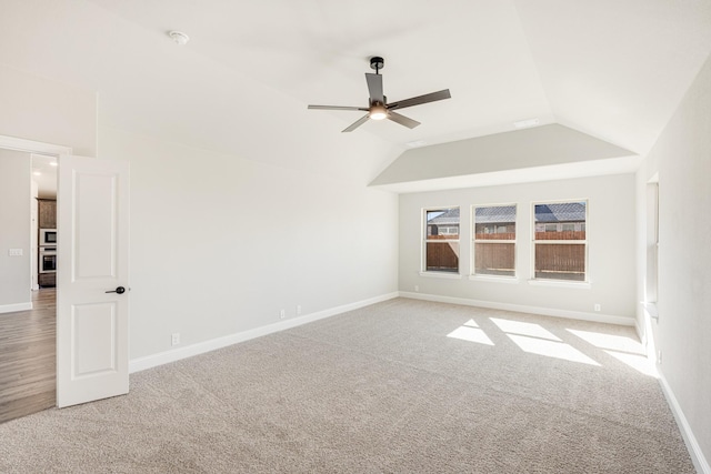 carpeted spare room featuring ceiling fan and lofted ceiling