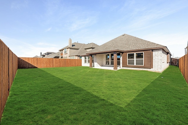 back of house with a yard and a patio area