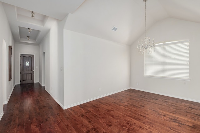 hallway with lofted ceiling, a notable chandelier, and dark hardwood / wood-style flooring