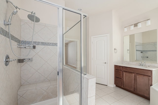 bathroom with vanity, a shower with door, and tile patterned flooring