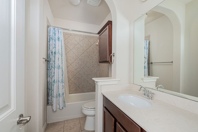 full bathroom featuring tile patterned floors, vanity, shower / bath combo with shower curtain, and toilet