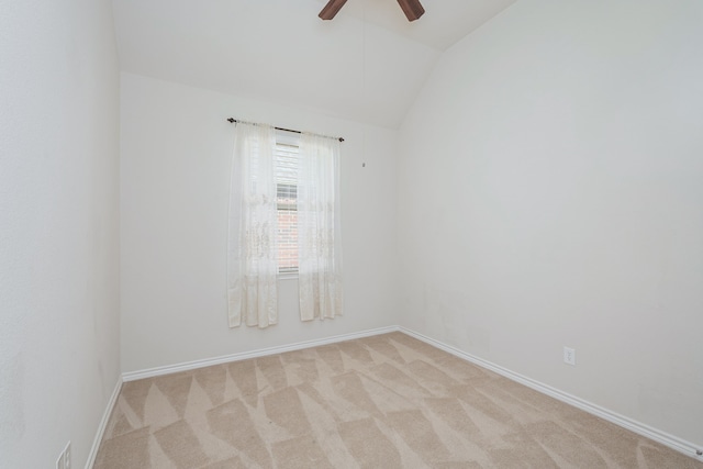 empty room with light carpet, ceiling fan, and vaulted ceiling