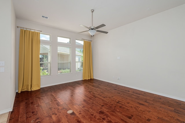 spare room featuring plenty of natural light, ceiling fan, and wood-type flooring